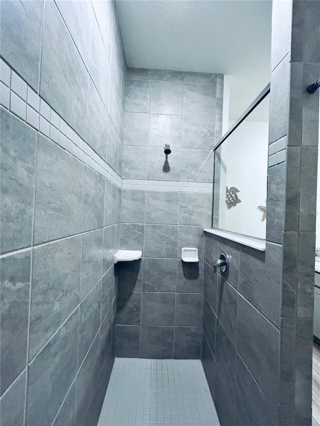 full bath featuring tiled shower