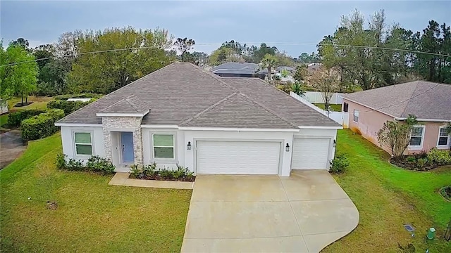 ranch-style home with driveway, roof with shingles, stucco siding, a front lawn, and a garage