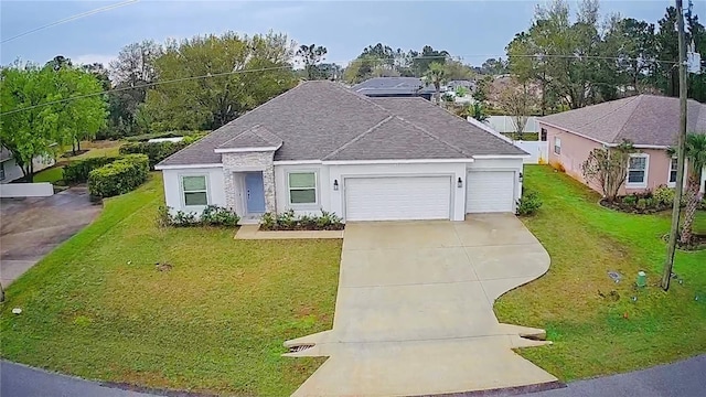 ranch-style house featuring a front lawn, a garage, driveway, and roof with shingles