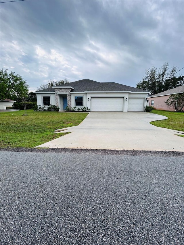 view of front facade featuring stucco siding, a front lawn, concrete driveway, an attached garage, and a shingled roof