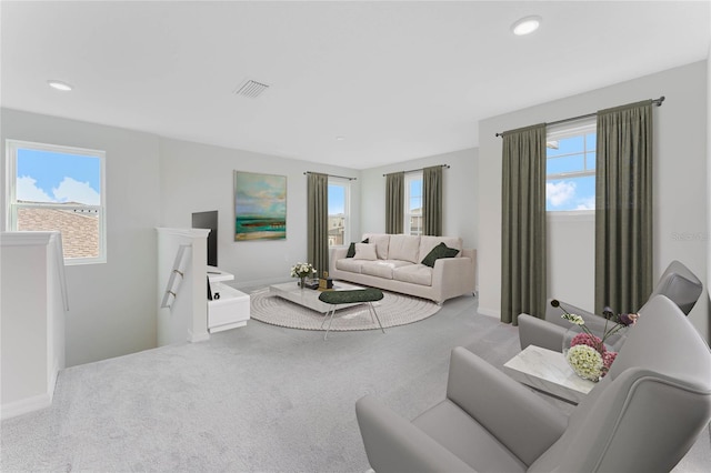 carpeted living area with recessed lighting, visible vents, and baseboards