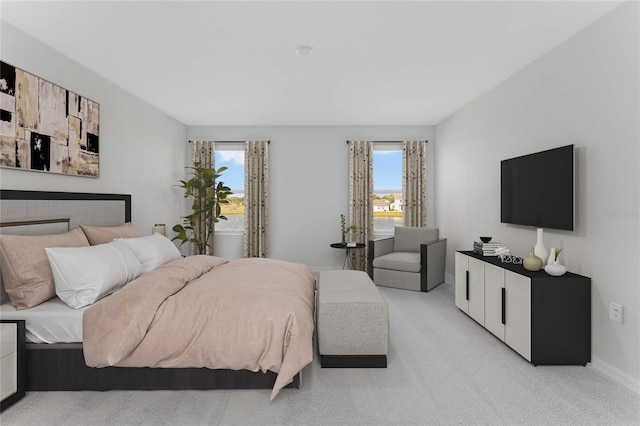 bedroom featuring baseboards and light carpet