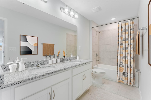 bathroom featuring tile patterned floors, double vanity, shower / tub combo with curtain, and a sink