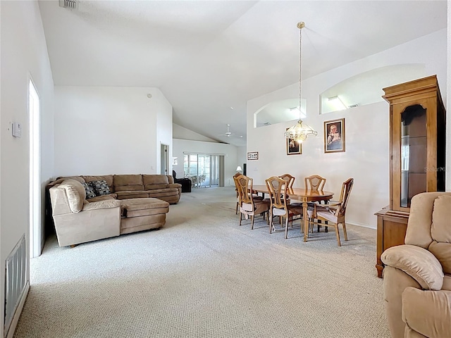 carpeted living room with visible vents and high vaulted ceiling