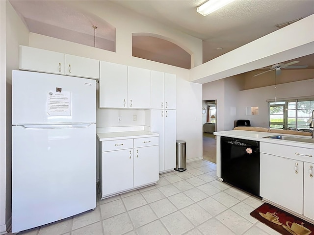 kitchen with a ceiling fan, freestanding refrigerator, a sink, light countertops, and black dishwasher