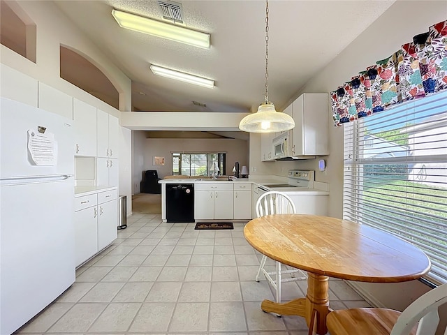 kitchen featuring visible vents, white appliances, light countertops, light tile patterned floors, and vaulted ceiling