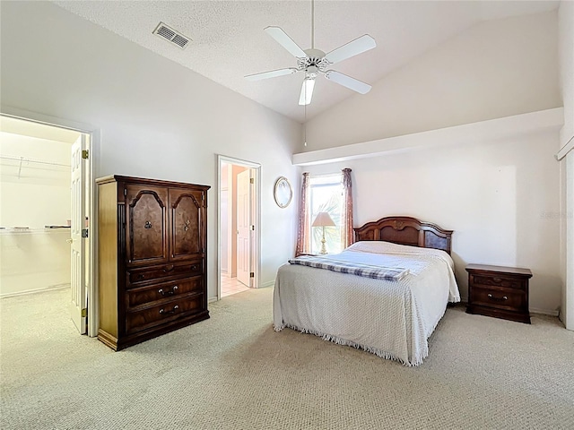 bedroom featuring visible vents, carpet floors, high vaulted ceiling, ceiling fan, and a textured ceiling