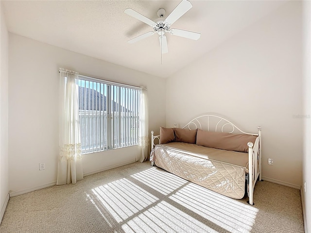 bedroom featuring baseboards, carpet, ceiling fan, and vaulted ceiling