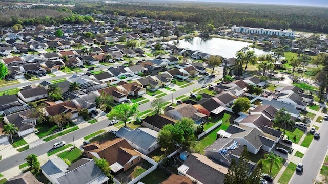 drone / aerial view featuring a residential view and a water view