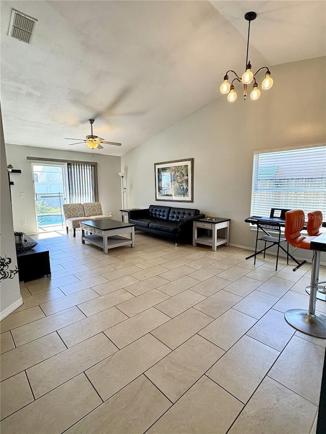 living room featuring high vaulted ceiling, ceiling fan with notable chandelier, visible vents, and baseboards