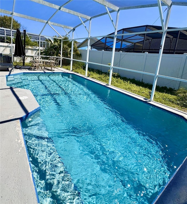 view of pool featuring a fenced in pool, a patio, a lanai, and fence