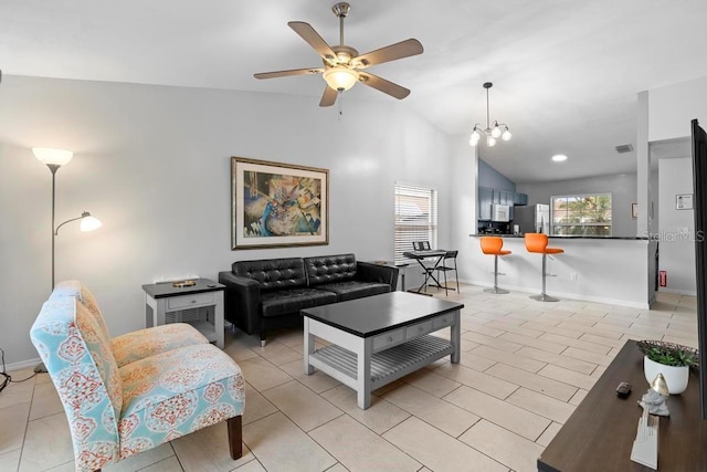 living area featuring vaulted ceiling, light tile patterned floors, baseboards, and ceiling fan