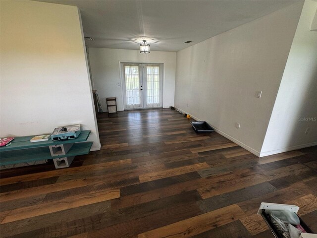 spare room featuring french doors, baseboards, visible vents, and wood finished floors