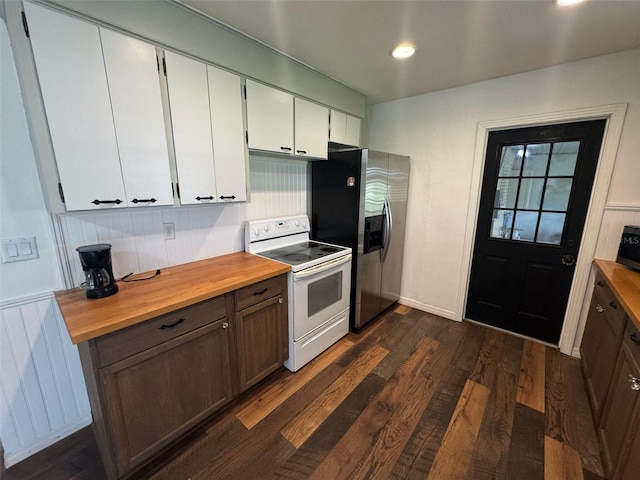 kitchen with radiator, dark wood finished floors, stainless steel appliances, white cabinetry, and butcher block counters