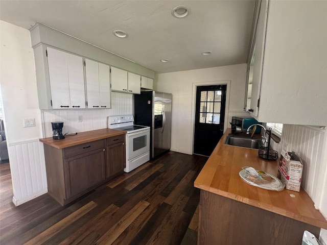 kitchen with white range with electric cooktop, dark wood finished floors, butcher block counters, stainless steel refrigerator with ice dispenser, and a sink