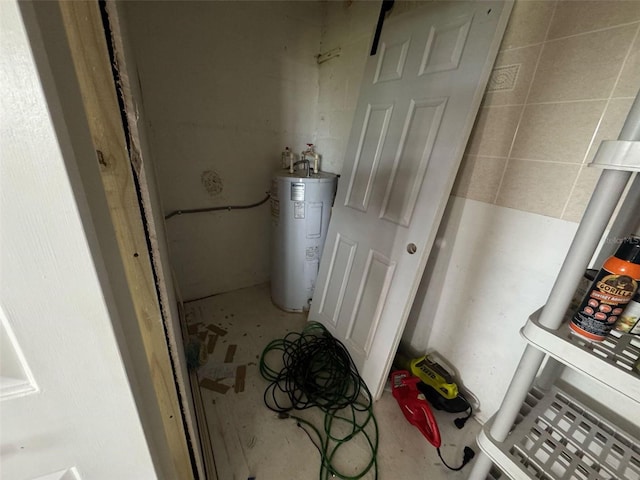 utility room with electric water heater