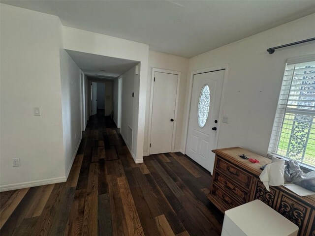 foyer entrance featuring dark wood-type flooring and baseboards