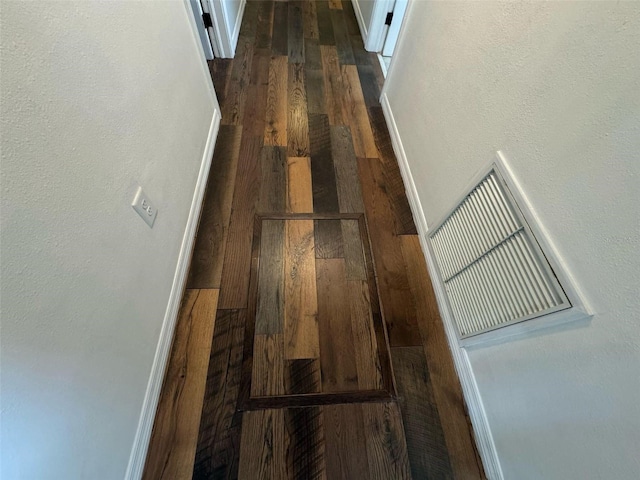 interior details with visible vents, baseboards, and wood finished floors