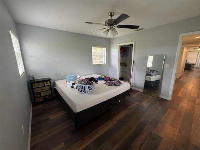 bedroom featuring visible vents, baseboards, a ceiling fan, and dark wood-style flooring