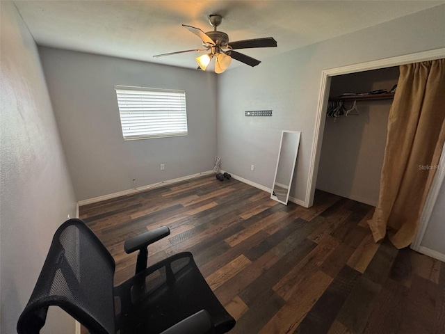 unfurnished bedroom featuring a closet, baseboards, ceiling fan, and dark wood-style flooring