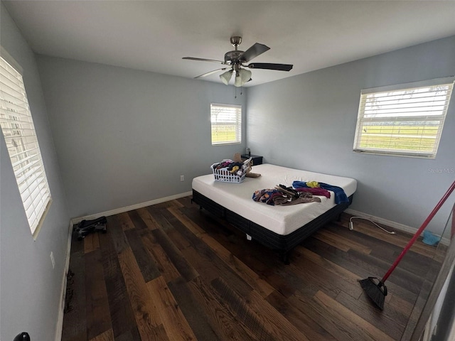 bedroom featuring a ceiling fan, wood finished floors, and baseboards