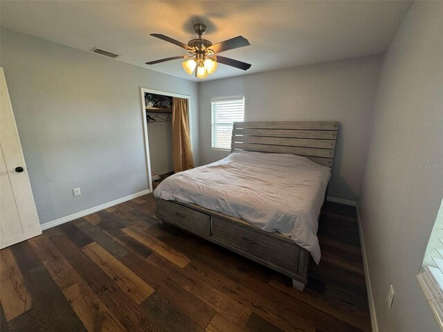 bedroom with visible vents, dark wood-type flooring, baseboards, a closet, and a ceiling fan