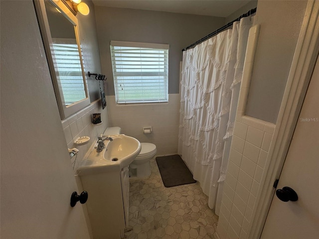 bathroom featuring vanity, tile walls, curtained shower, and toilet