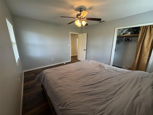 bedroom featuring visible vents, ceiling fan, baseboards, wood finished floors, and a closet