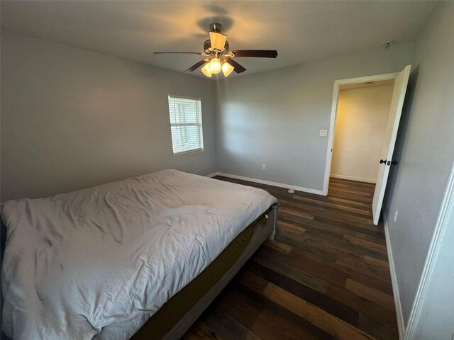 bedroom featuring ceiling fan, baseboards, and wood finished floors