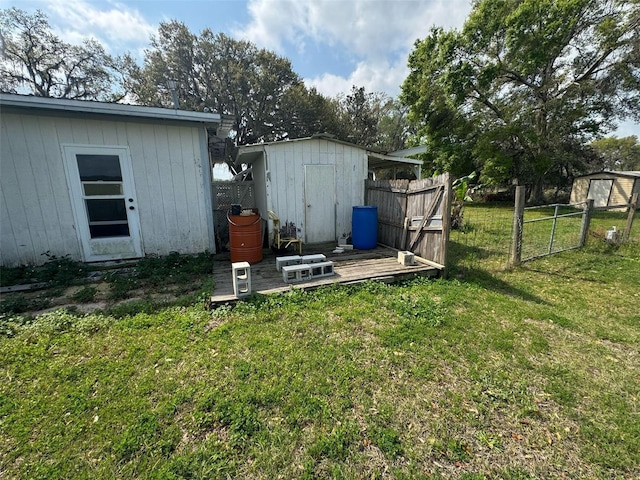 view of yard with an outbuilding, fence, and a shed