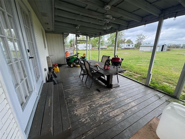 deck with a yard, a carport, and ceiling fan