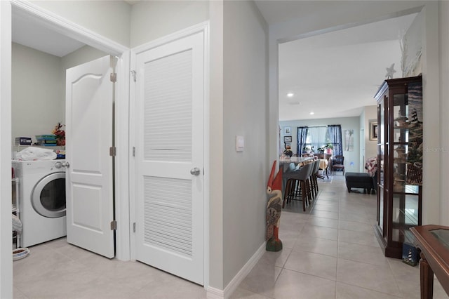 washroom featuring washing machine and dryer, recessed lighting, light tile patterned flooring, baseboards, and laundry area