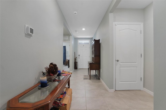 hall featuring light tile patterned floors, recessed lighting, and baseboards