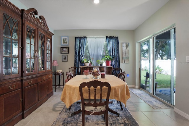 dining space featuring light tile patterned floors and baseboards