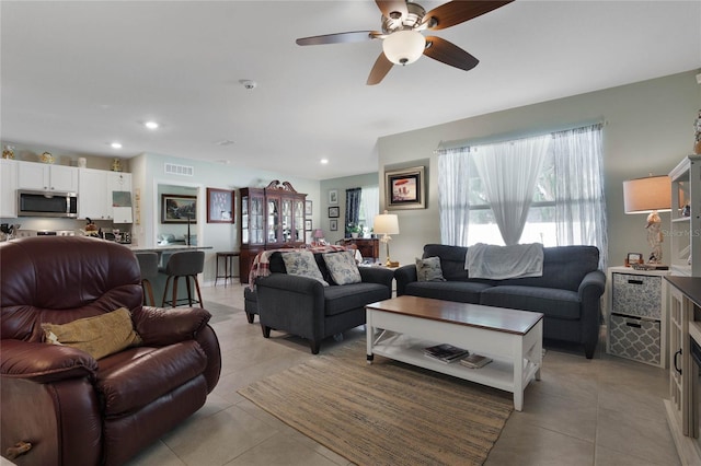 living room with light tile patterned floors, recessed lighting, visible vents, and ceiling fan