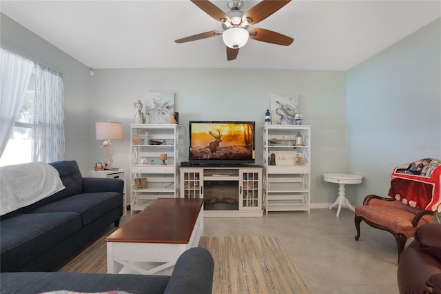 tiled living room featuring a fireplace and baseboards