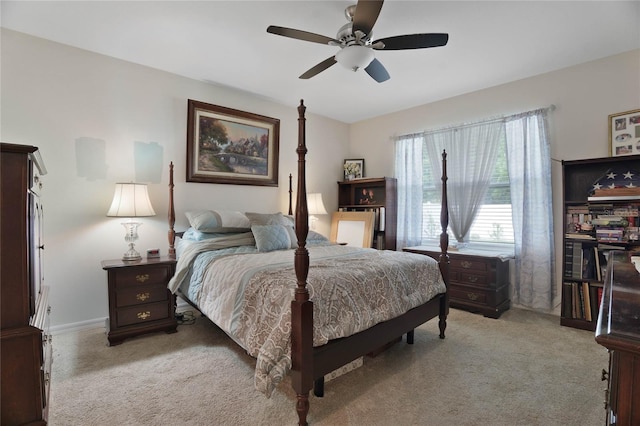 bedroom with light colored carpet, baseboards, and ceiling fan