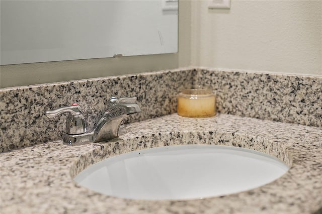 interior details featuring backsplash and a sink