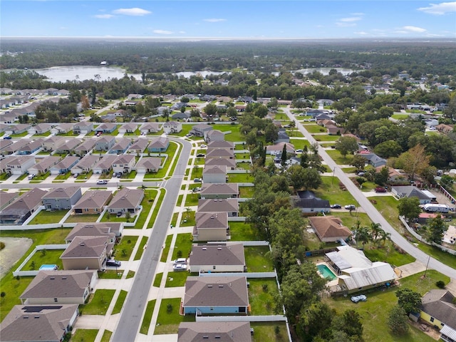 birds eye view of property with a water view and a residential view