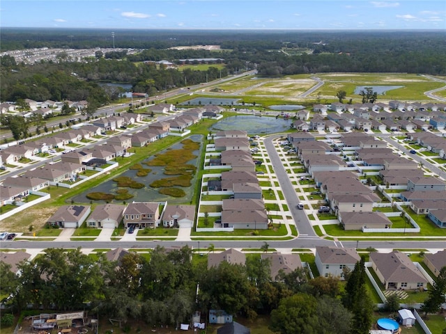 drone / aerial view with a residential view and a water view