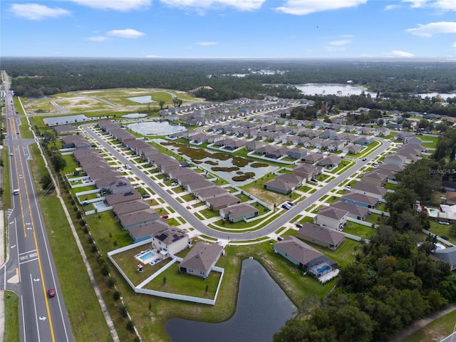 drone / aerial view with a water view and a residential view