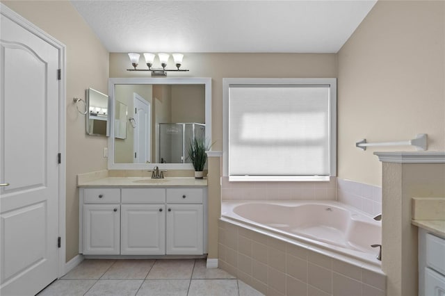 full bath featuring a bath, a shower stall, tile patterned floors, and vanity