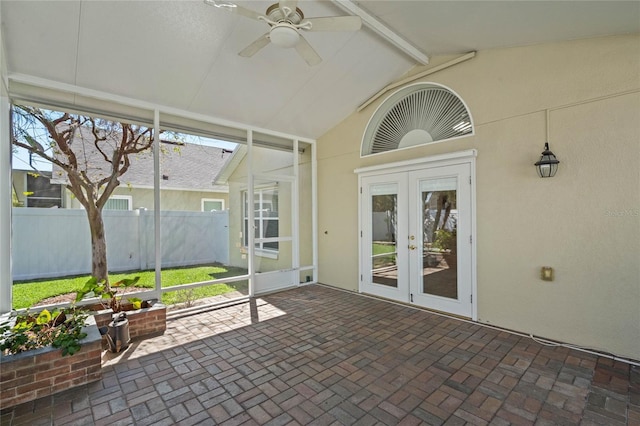 unfurnished sunroom with french doors, lofted ceiling with beams, and ceiling fan