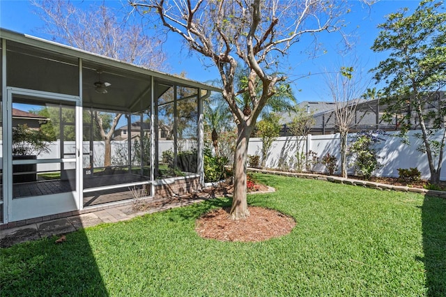 view of yard with fence and a sunroom