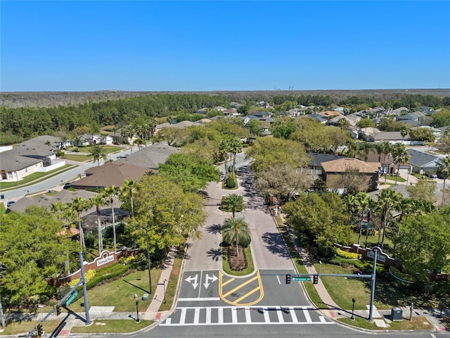 birds eye view of property featuring a forest view and a residential view