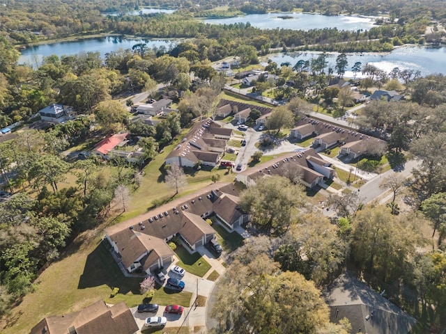 birds eye view of property with a residential view, a forest view, and a water view