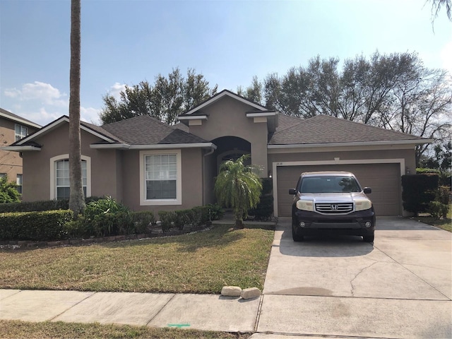 single story home with a shingled roof, a front lawn, concrete driveway, stucco siding, and an attached garage