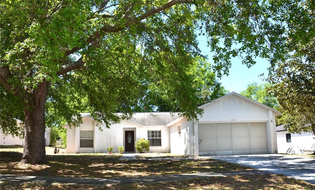 12312 Woodglen Cir, Clermont, FL 34711 - view of front of home featuring concrete driveway and an attached garage