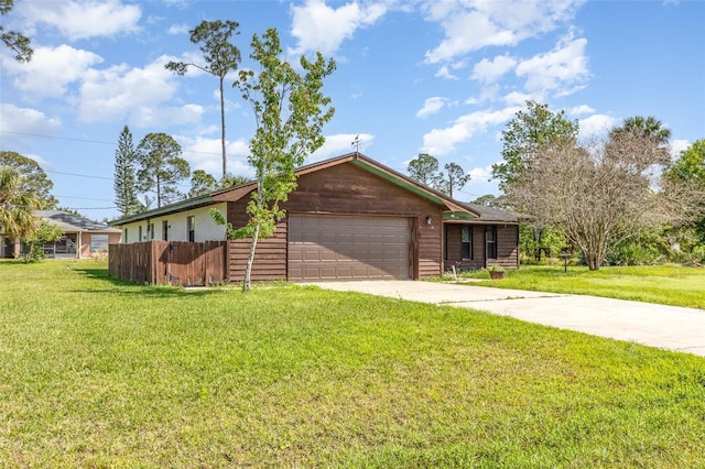 ranch-style house with an attached garage, concrete driveway, a front lawn, and fence