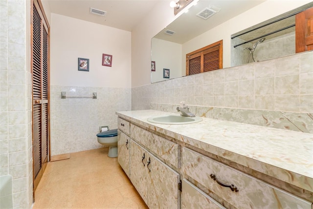 full bath with visible vents, toilet, tile walls, and vanity